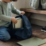 Kindergarten child packing a school bag during a morning routine