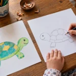 Child drawing and coloring a friendly turtle with pencils at a wooden table